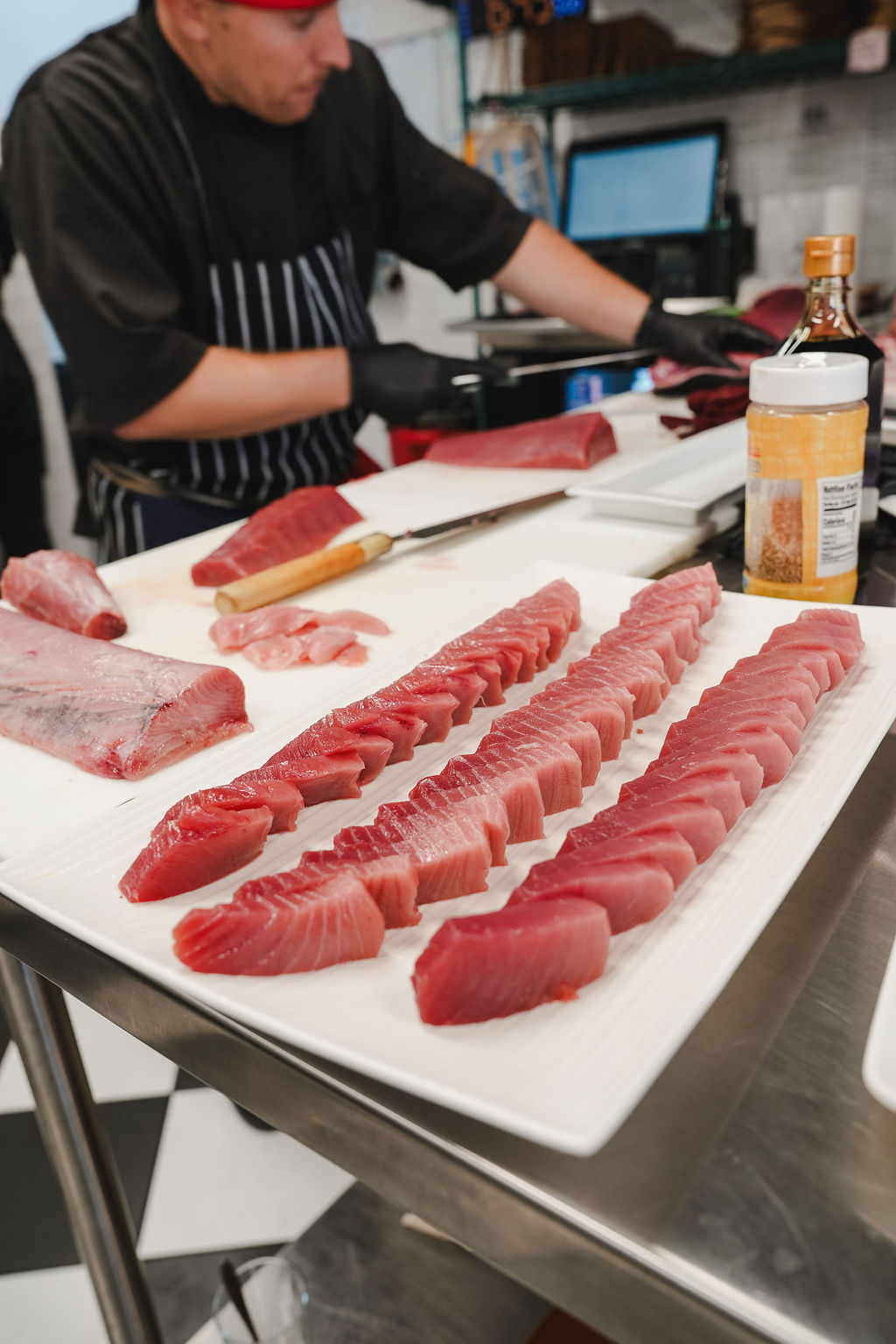 Rows of bluefin sliced lean to fat on a board.