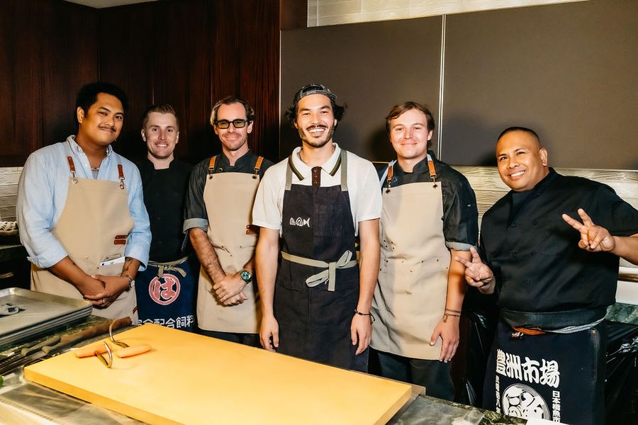 The Otoro Club team behind the board.