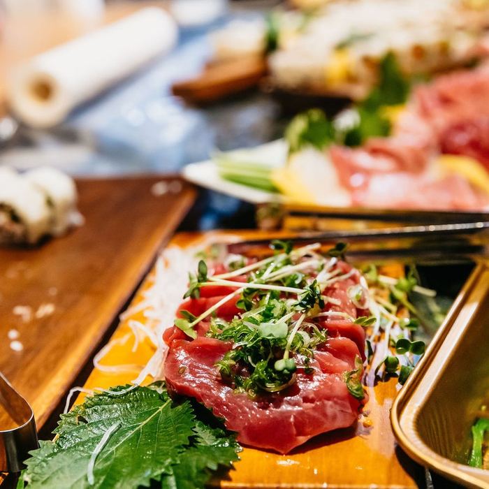 Sashimi dressed with herbs.