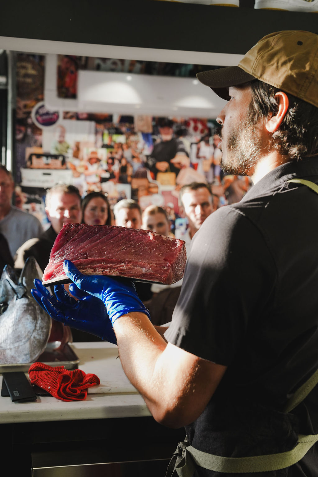 An itamae lifting a whole bluefin loin.