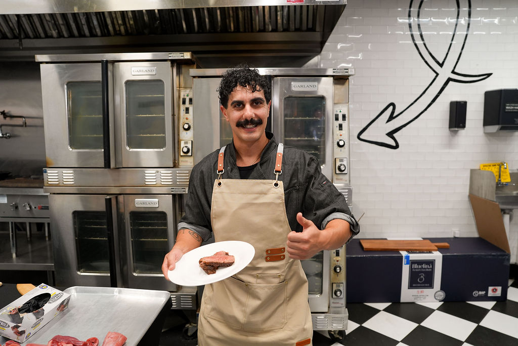 Armand Vasseghi presenting a plate.